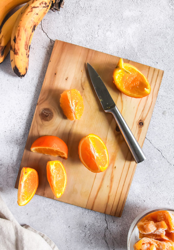 Chopping freshly sliced oranges